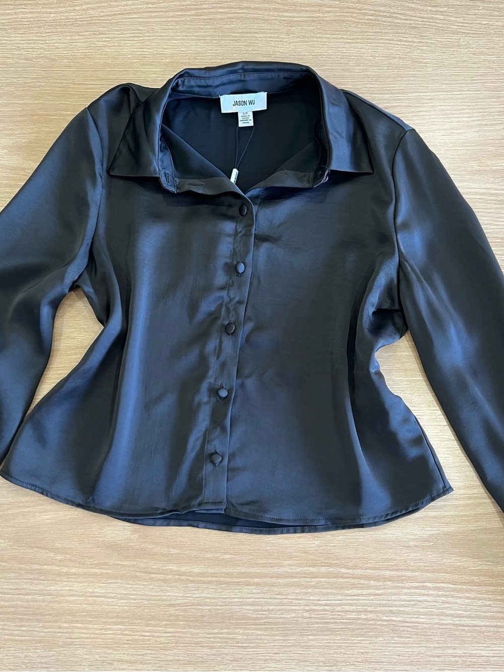 Elegant Jason Wu black satin blouse with a sophisticated, silky finish and class